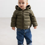 Dark blue denim jeans for children with rolled cuffs and visible pockets.