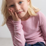 Pink children's T‑shirt with long sleeves and a round neckline