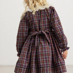 Dark checkered dress set viewed from the back with a bow at the waist and button placket