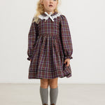 Dark checkered dress with white collar, long sleeves and gathered skirt