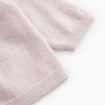 Pink knitted rib edge at the bottom of the cardigan and at the sleeve opening.