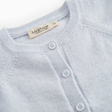 Details of light blue cardigan: round neckline and buttons along the front