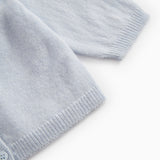 Light blue cardigan with ribbed cuffs and hem.