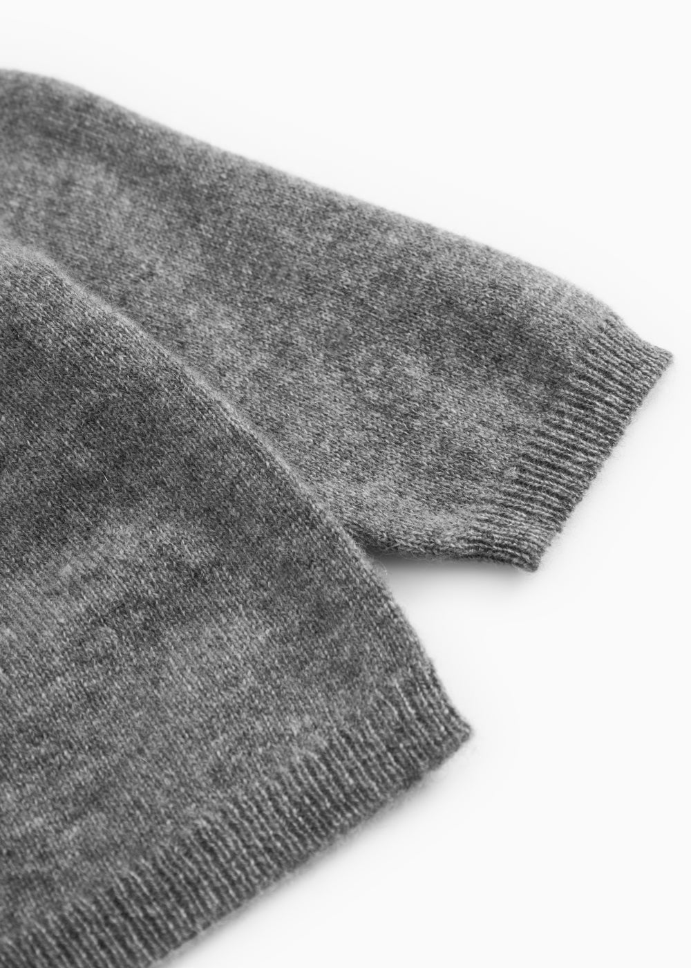 Gray heathered cashmere cardigan with ribbed cuffs and hem.