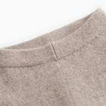 High-rise Kashmir trousers and alpaca melange, close-up of seam and fabric texture in light brown.
