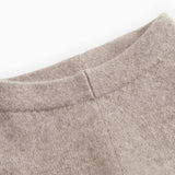 High-rise Kashmir trousers and alpaca melange, close-up of seam and fabric texture in light brown.