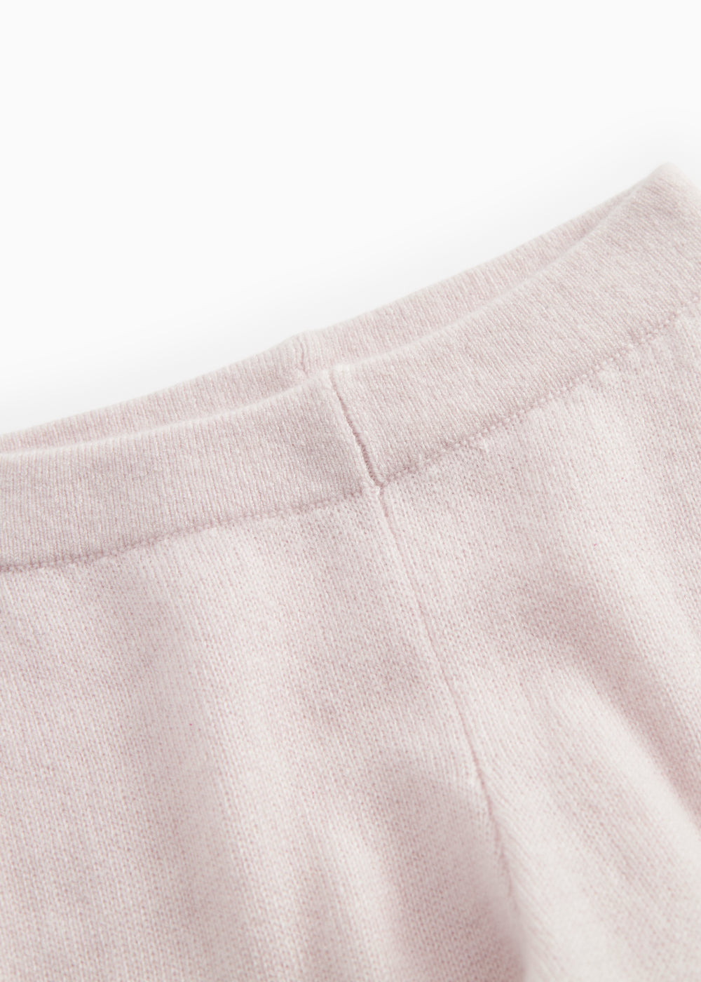 Pink merino wool sweater with soft lining and stitching at the top of the sleeves.