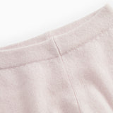 Pink merino wool sweater with soft lining and stitching at the top of the sleeves.