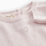 Pink cashmere blend dress with ribbed edge and button closure at the neckline.