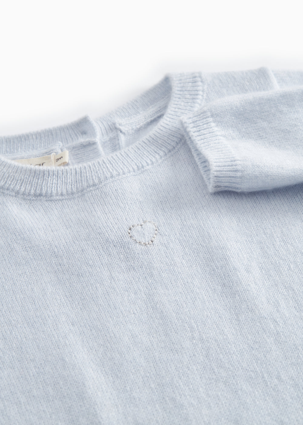 Kashmir jacket in light blue melange with a subtle embroidered motif on the chest.