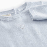 Kashmir jacket in light blue melange with a subtle embroidered motif on the chest.