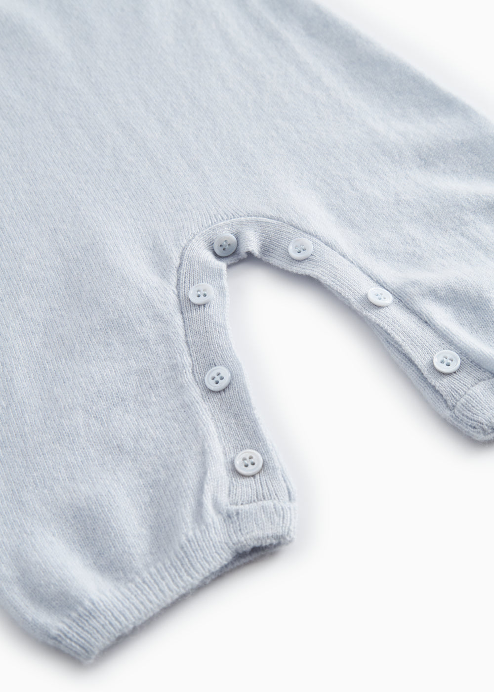 Kashmir jacket in light blue melange with button closure at the neckline.
