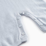 Kashmir jacket in light blue melange with button closure at the neckline.
