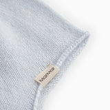 Light blue baby hat in knit with MarMar textile label on the fold edge.