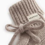 Knitted baby socks in gray-beige blend with ribbed edge and MarMar label, bow in front.