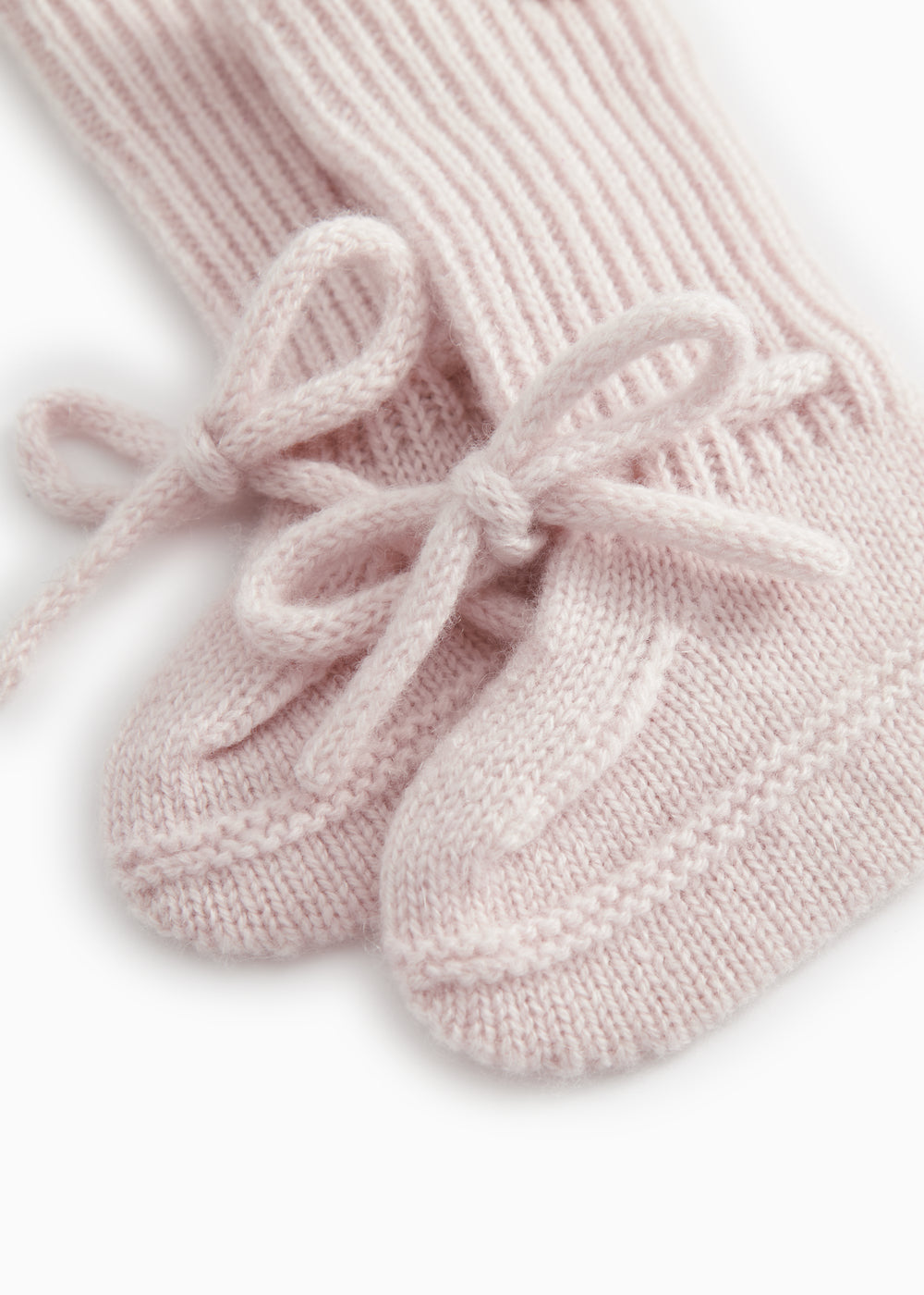Pink knitted baby shoes with laces and rib pattern