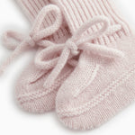 Pink knitted baby shoes with laces and rib pattern