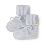 With light blue knitted baby shoes with laces and MarMar brand.