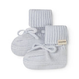 With light blue knitted baby shoes with laces and MarMar brand.
