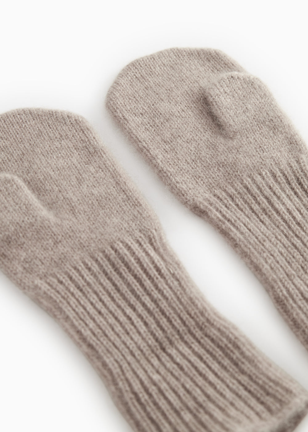 Baby cardigan in gray melange knit, slanted with ribbed cuff and thumb hole.