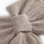 Baby scarf in alpaca blend, beige marled, tightly knitted knot and seam.