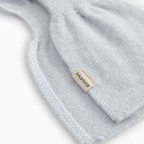 Light blue knitted cashmere scarf with edge stitching and small fabric label.
