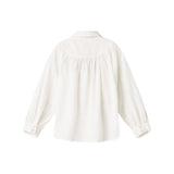 Hvid bluse til børn med broderet mønster og rund krave