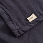 Stainless steel in dark blue with an embroidered label at the folded corner.
