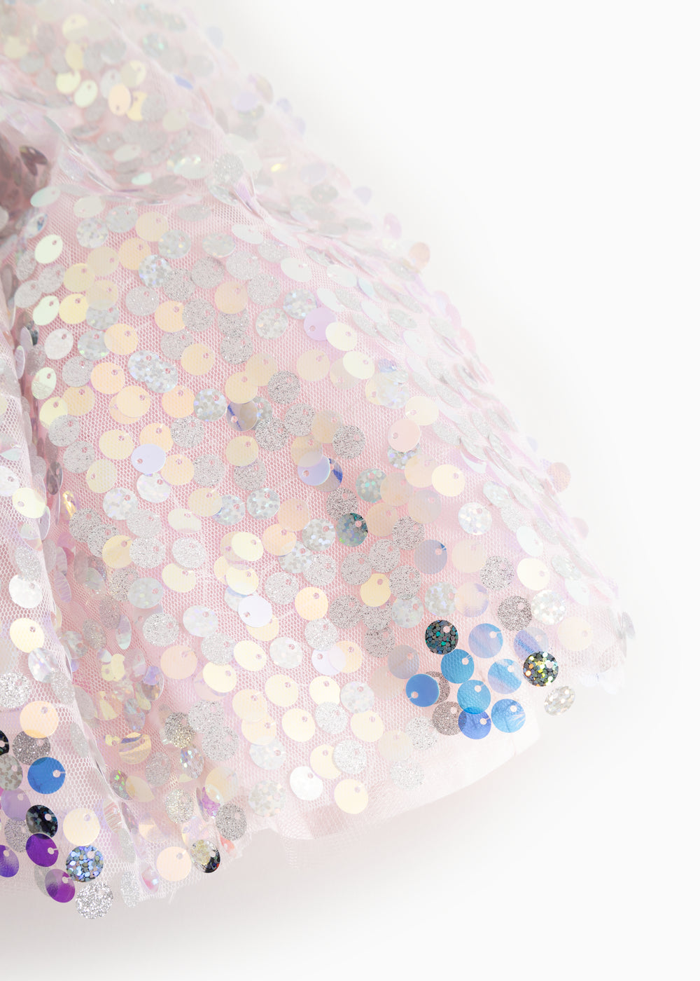 Close-up of a short-sleeved dress with silver glittering sequins and multicolored details.