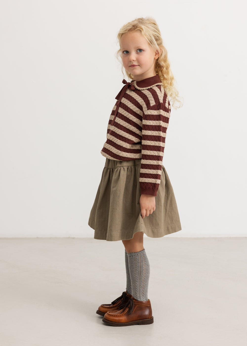 Brown A-line skirt with elastic waistband worn by child