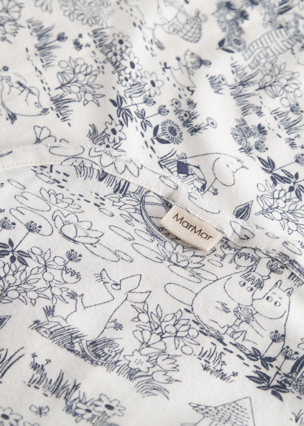 Baby blanket with Moomin print, rounded corners, and picot edges.