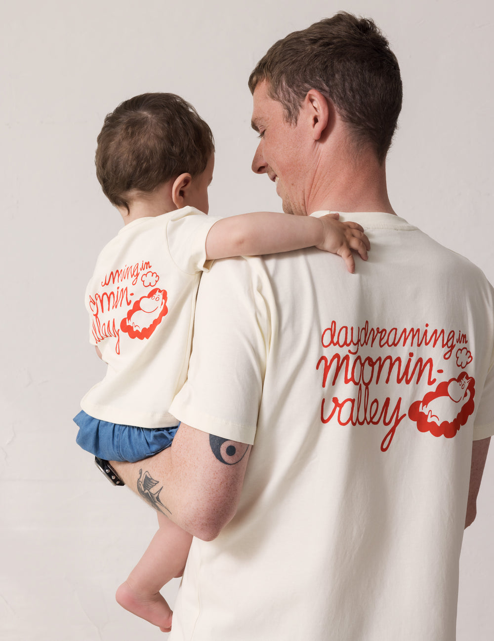 Adult and baby set back-to-back wearing matching T-shirts with Mumin print.