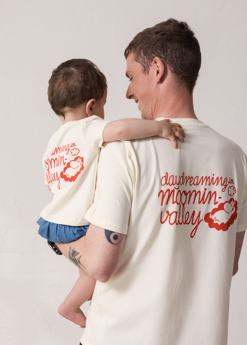 Adult and baby set back-to-back wearing matching T-shirts with Mumin print.