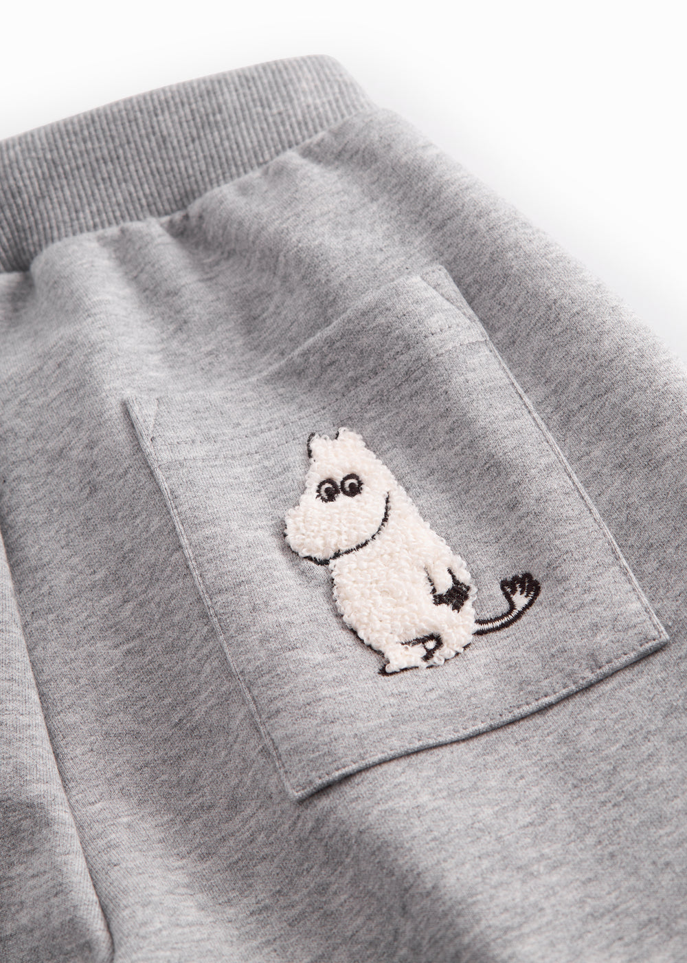 Gray sweatpants for children with Moomin print, elastic and drawstring.