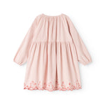 Pink children's dress with a pleated collar and red patterned trim along the hem.