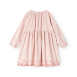 Pink children's dress with a pleated collar and red patterned trim along the hem.