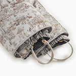 Light gray jumpsuit with hood and pattern, zipper and flap edge at the opening