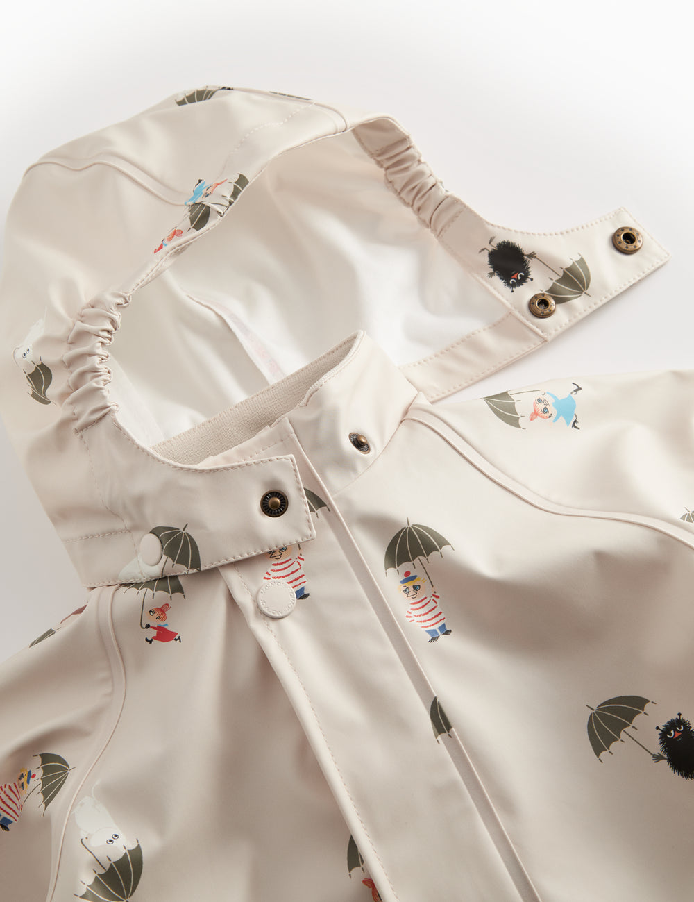 Beige baby raincoat with Moomin print, hat, and booties.