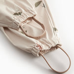 Beige baby raincoat with Moomin print, hat, and booties.