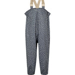 Børne-regnbukser i mørkeblå med små hvide blomster, justerbare seler og fodstropper