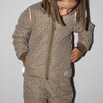 Barn iført ternet termojakke og matchende termobukser