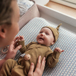 Baby i ribbstrikket brun heldragt til baby i blødt materiale med lange ærmer, lange ben, tryknapper og futter og brun babyhue