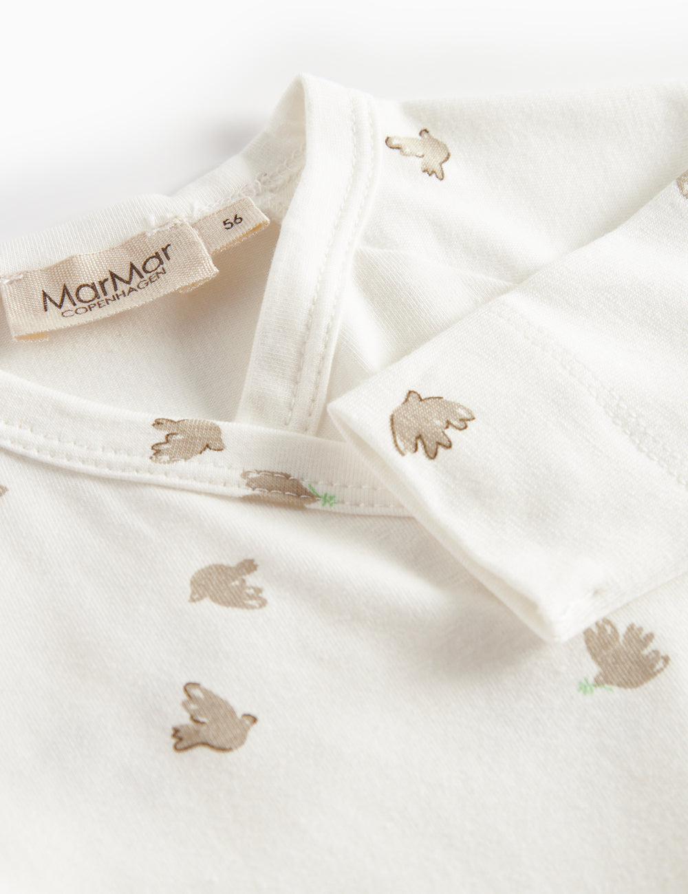 Long-sleeved bodystocking for newborns with wrap-around closure and bird pattern