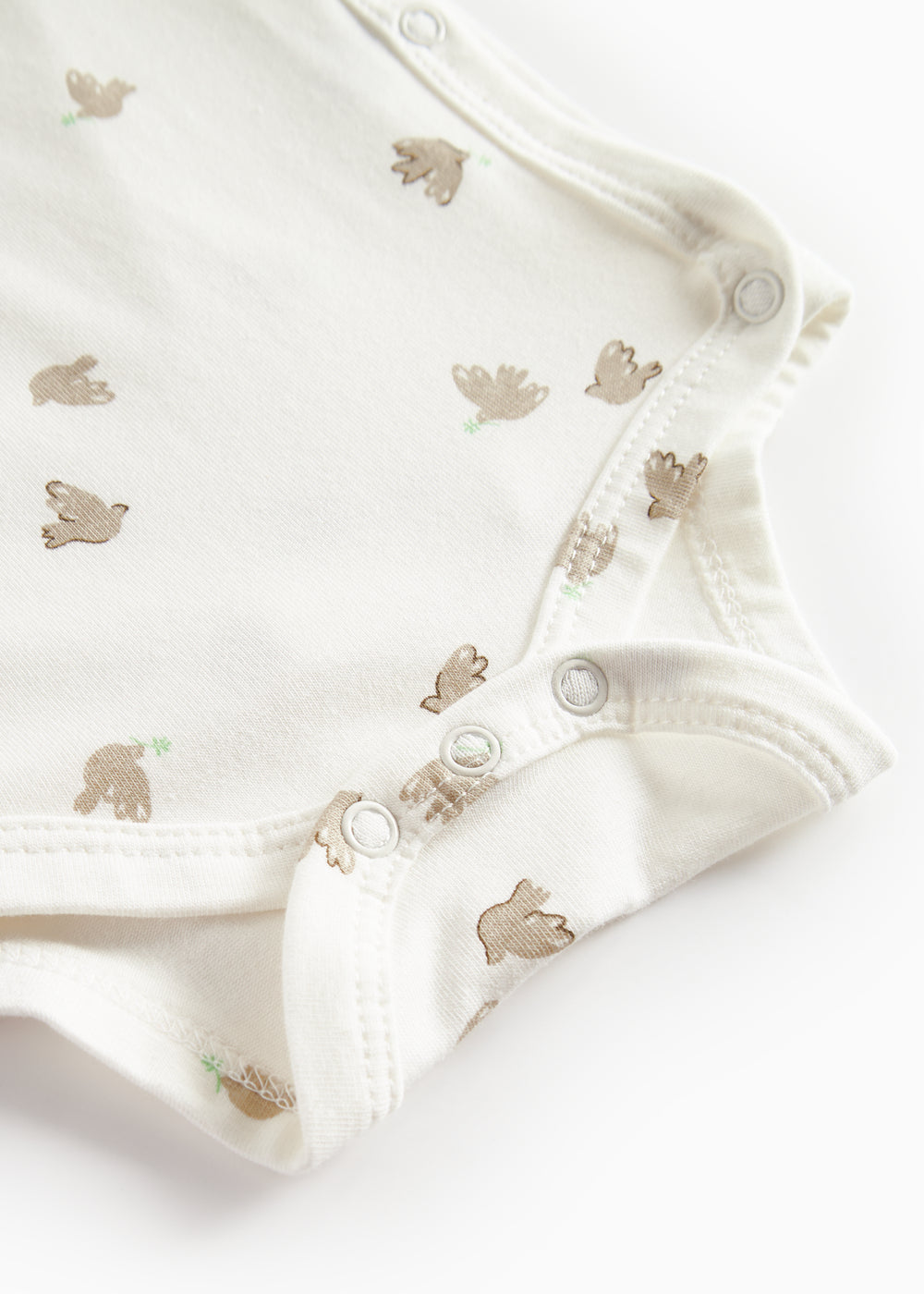 Langærmet bodystocking til nyfødte med slå-om-lukning og fuglmønster