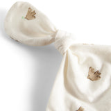 Nærbillede af sløjfe i blødt mønstret stof