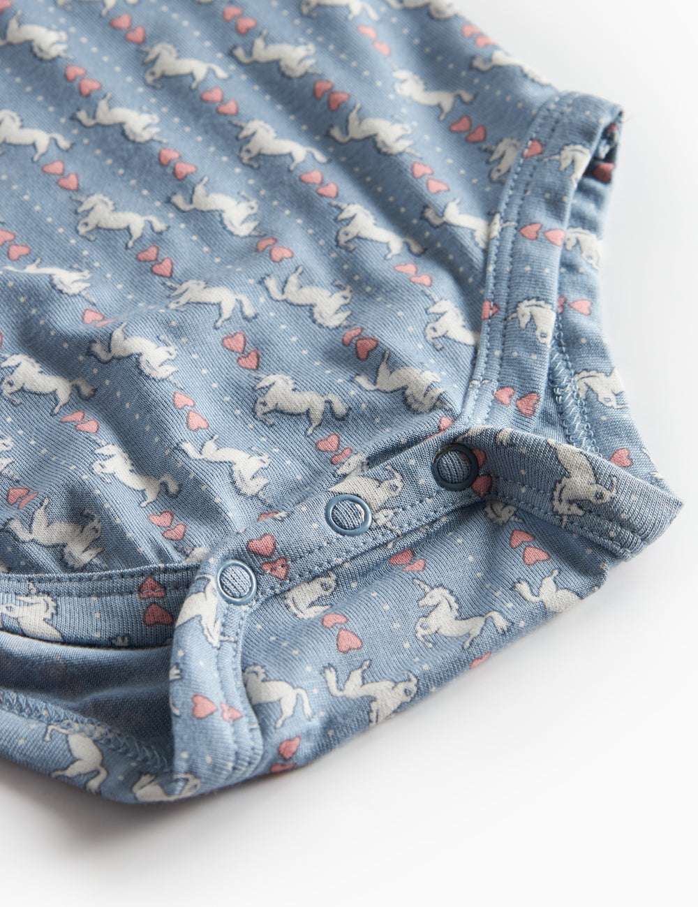 Blue long-sleeved bodysuit for baby with unicorn pattern and ruffle collar