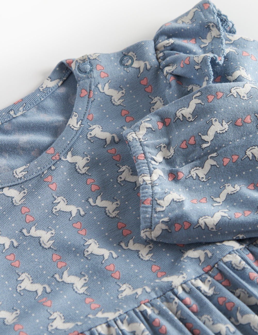 Blue dress-bodysuit for baby with unicorn pattern and ruffles on the shoulders