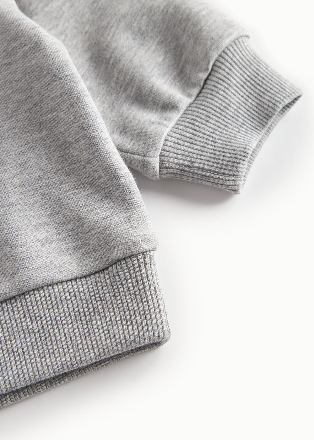 Nærbillede af ærmekant på grå sweatshirt til børn