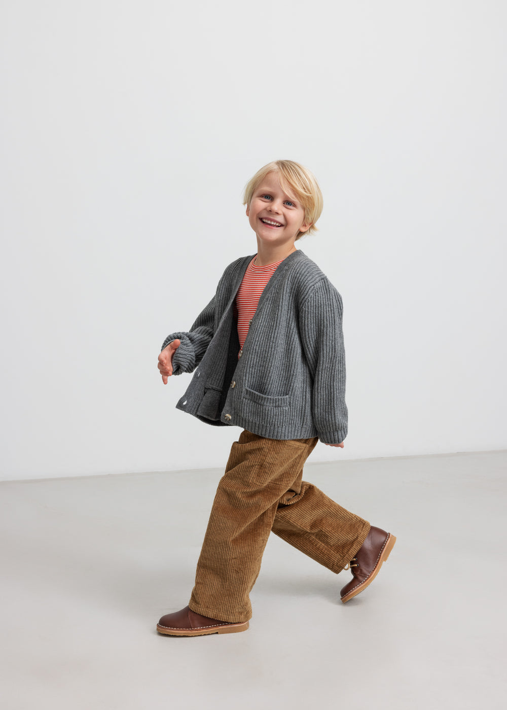 Dreng i brun fløjlsbuks med grå strikket cardigan