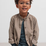 Dreng iført beige babyfløjlsskjorte og mørkeblå bluse